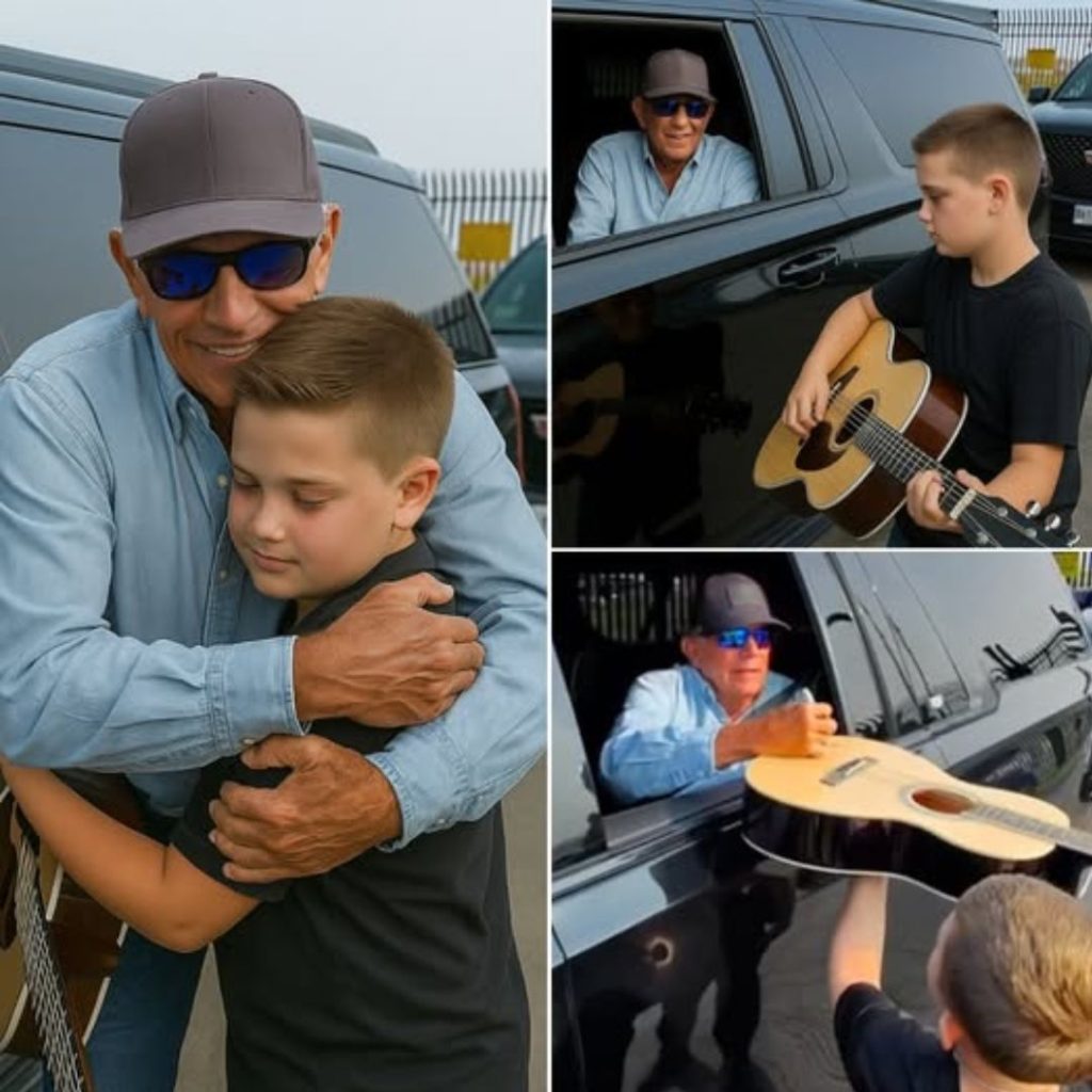 George Strait signing guitar